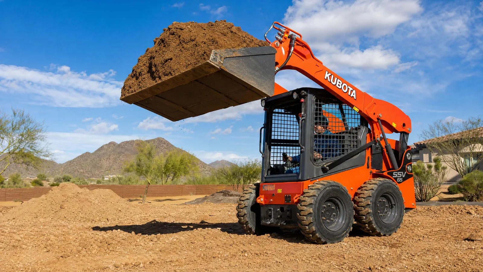 Kubota SSV65 heavy-duty skid steer rental from Rent A Loader Phoenix with enclosed cab